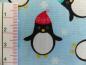 Preview: Patchworkstoff Pinguine mit Mütze auf helltürkis. Von Timeless Treasures. Detailansicht.
